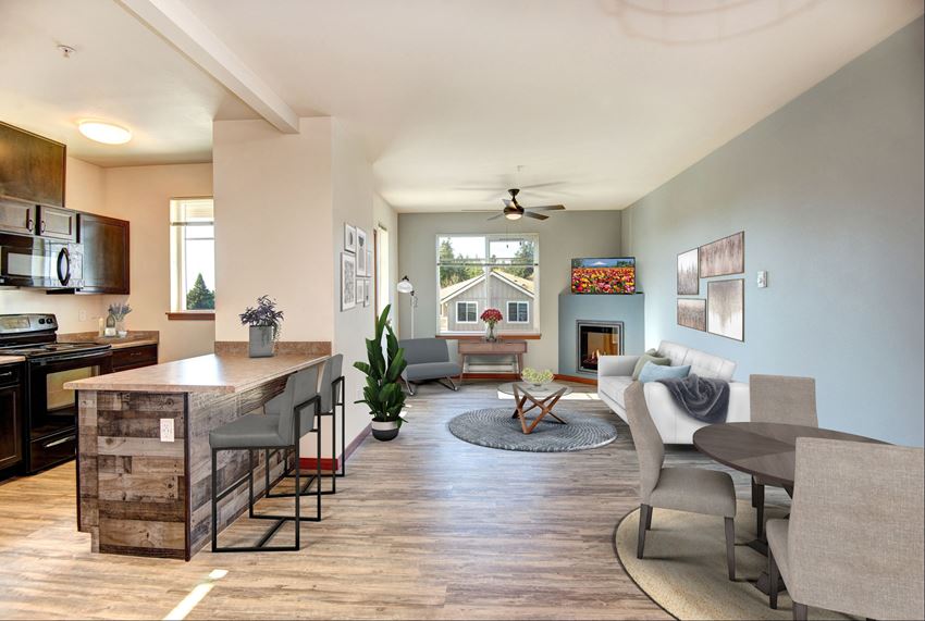an open living room with a kitchen and a dining table