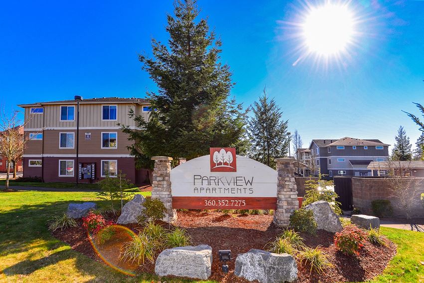 the preserve at pinnacle apartments sign in front of building with sunburst