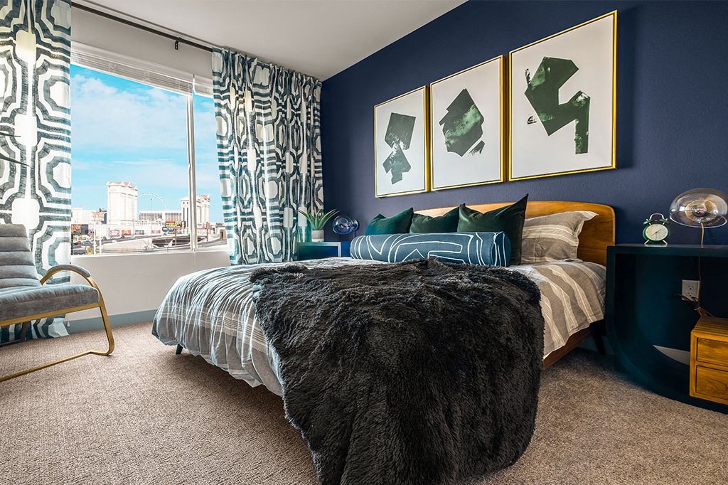 a bedroom with a bed and a large window