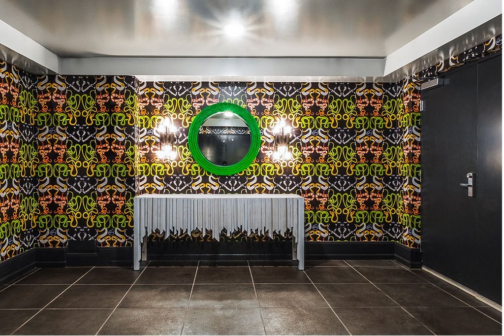 a room with a radiator and a green circle on the wall