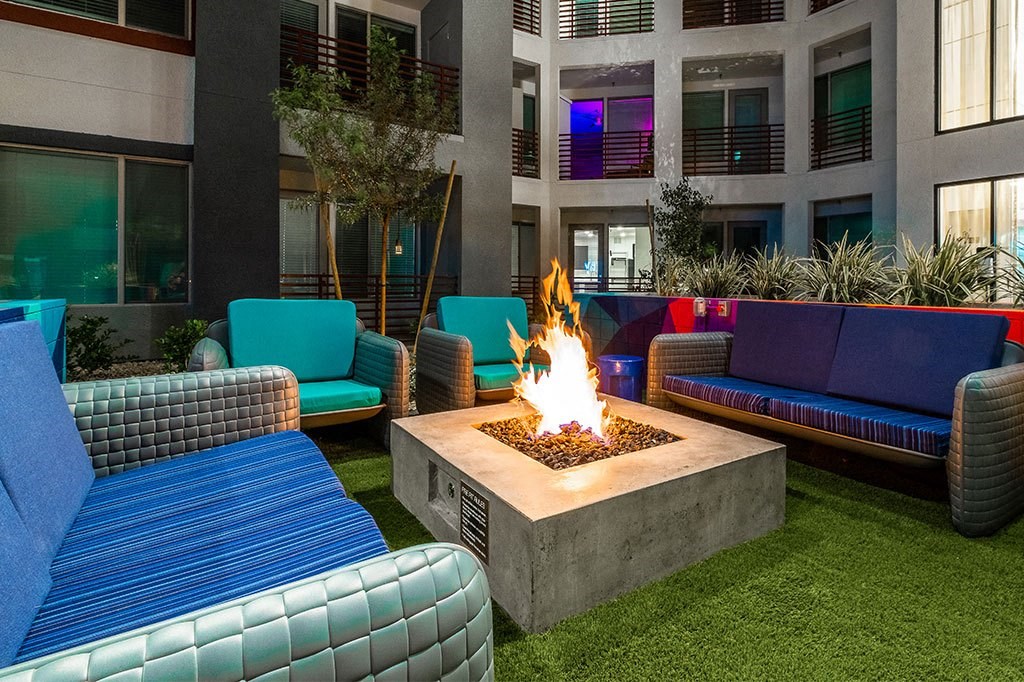 a seating area with a fire pit in a courtyard