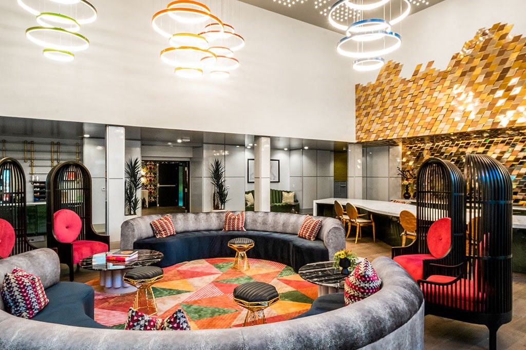 a lounge area with couches and chairs and a table