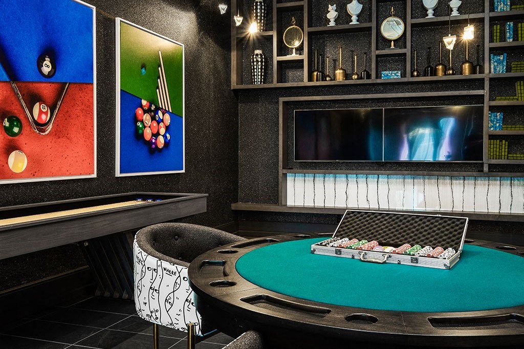 a game room with a pool table and a television