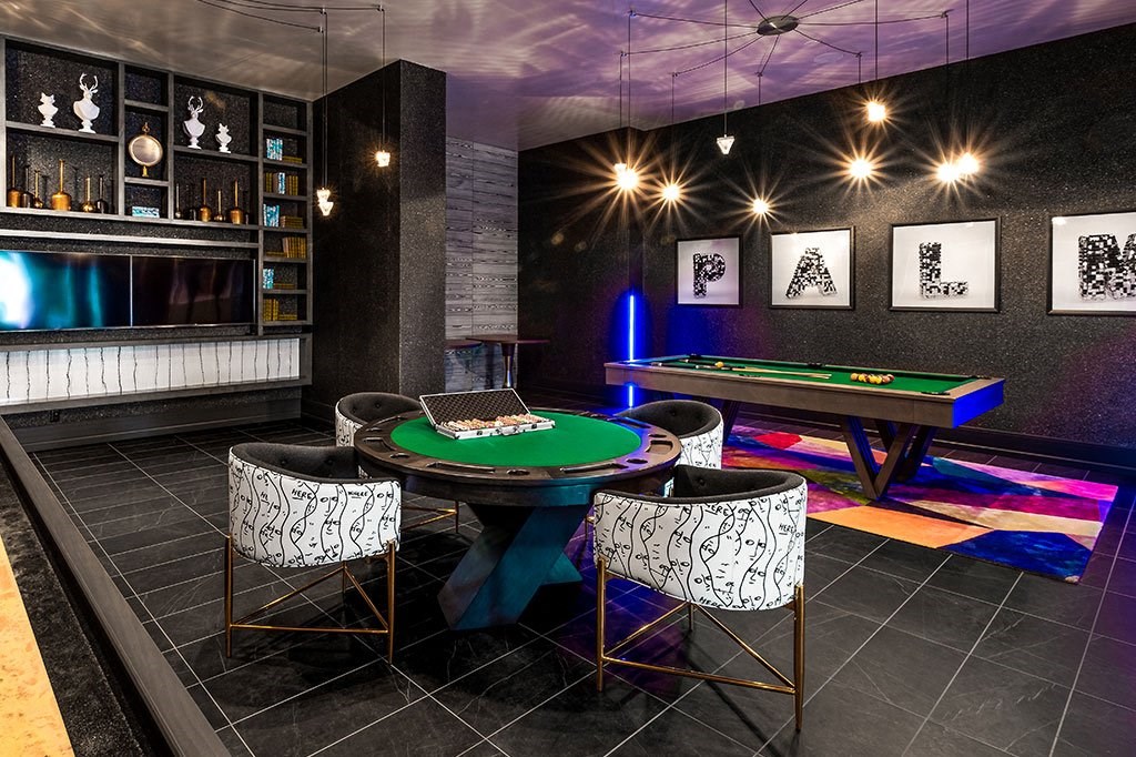 a gaming room with a pool table and a bar