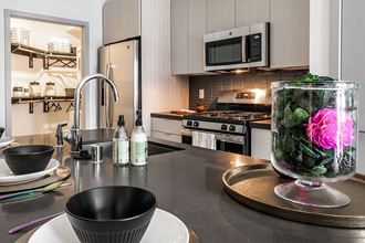 a kitchen with a vase of flowers on the counter