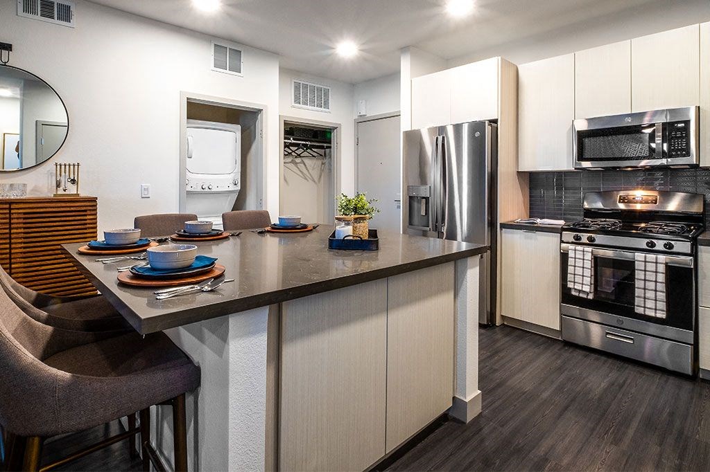 a kitchen with a large counter with plates on it