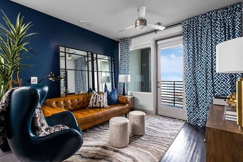 a living room with blue walls and a leather couch