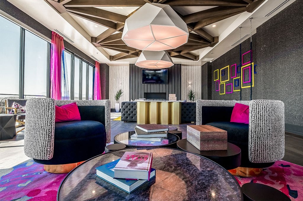 a living room with couches and a table with books