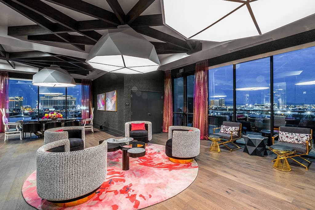 a living room with a view of the city at night