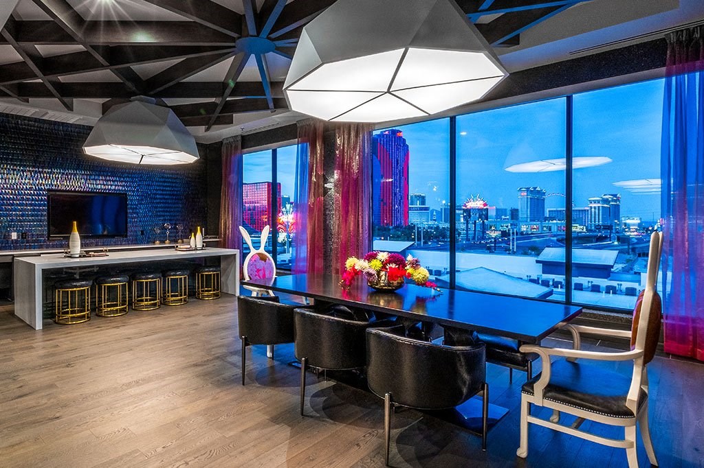 a dining room with a table and a view of the city