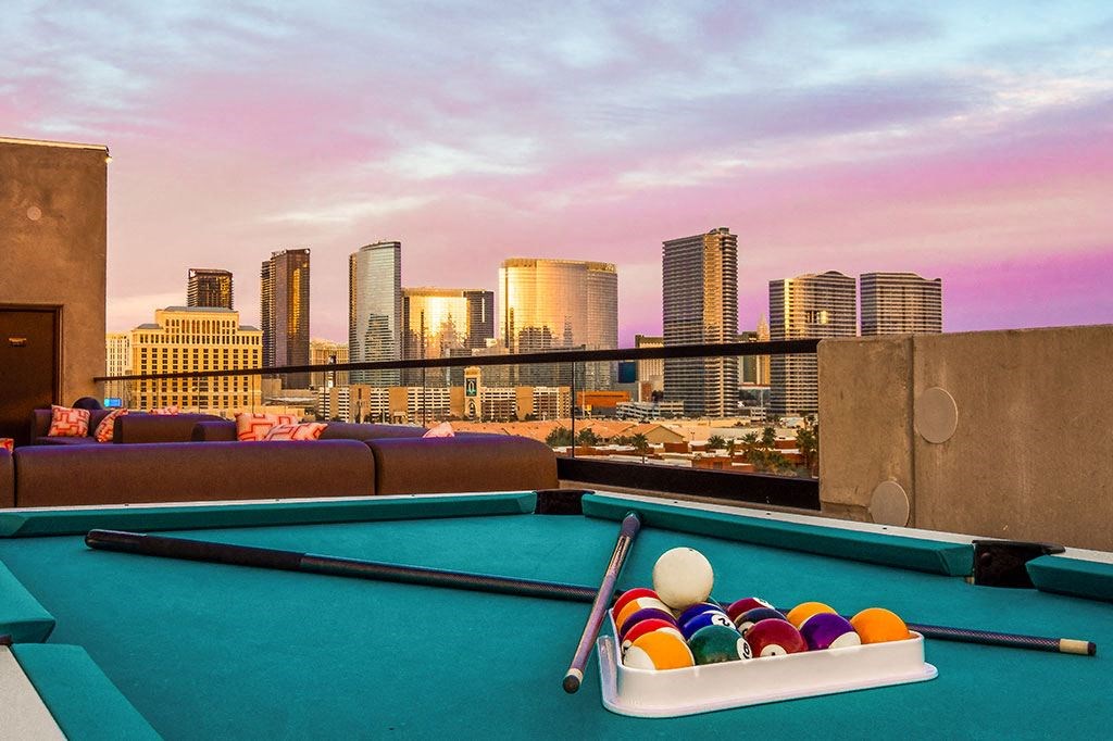 a pool table with a city skyline in the background