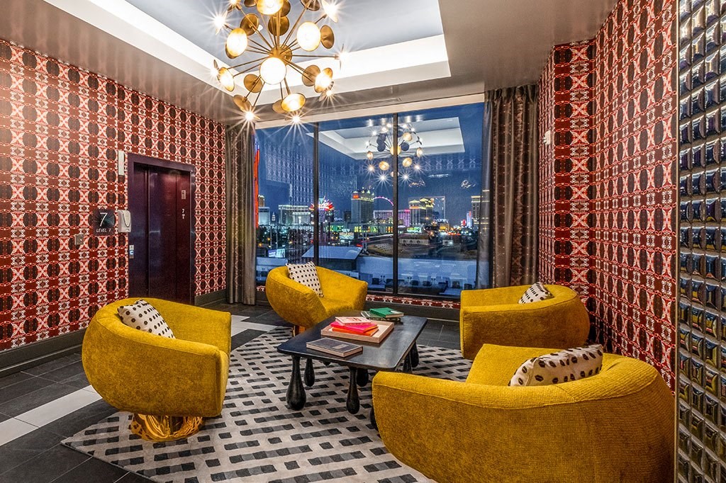 a living room with yellow chairs and a large window