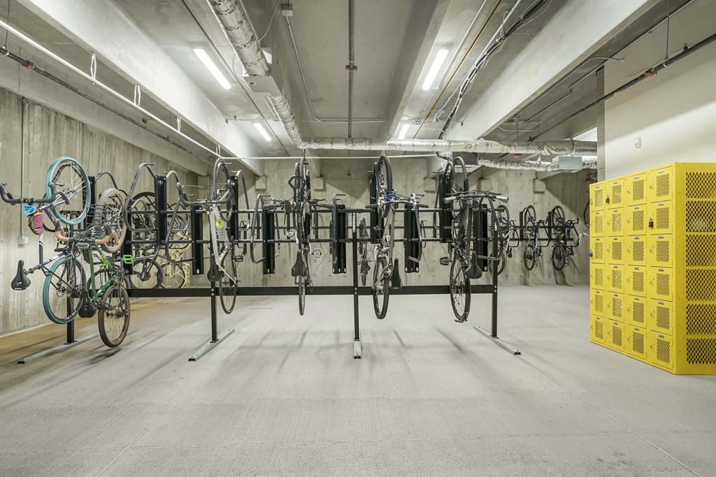 a room full of bikes on racks in a parking garage