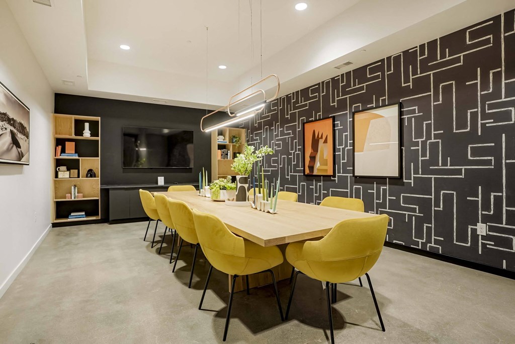 a dining room with a wooden table and yellow chairs