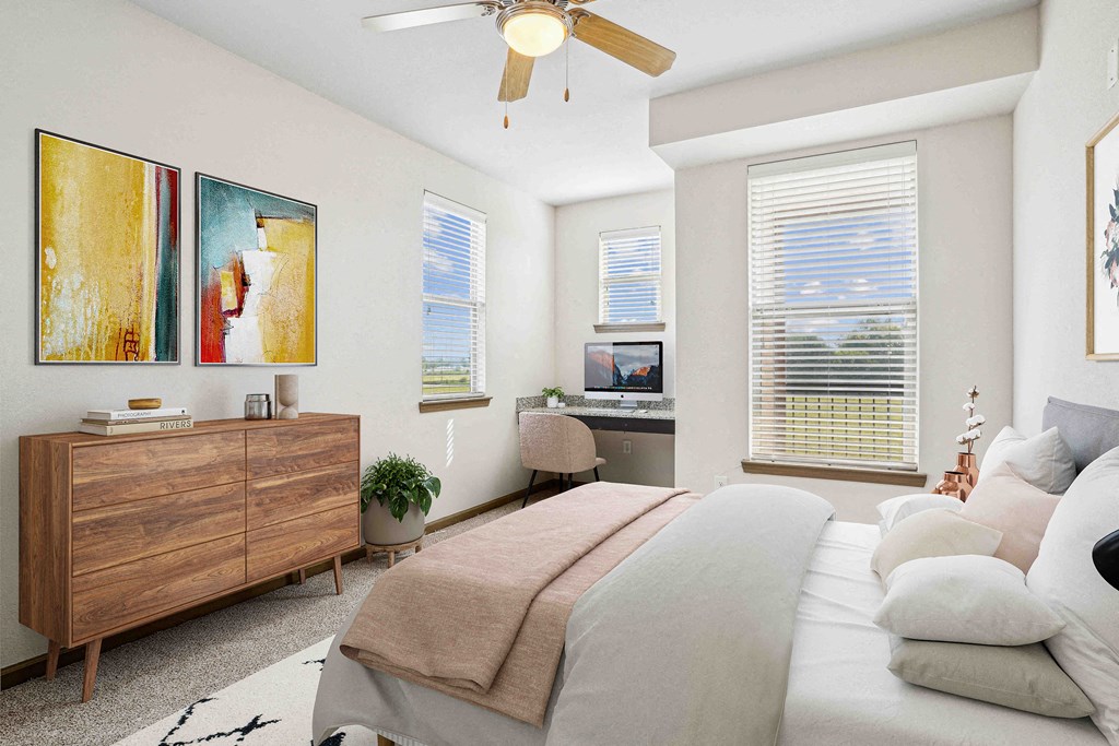 Pet-Friendly Rentals in Bentonville, AR – Parc at Bentonville – A bedroom with a bed, dresser, and a ceiling fan.
