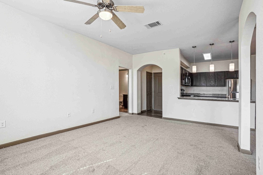 1 & 2-Bedroom Apartments for Rent in Bentonville, AR – Parc at Bentonville – Living Room with ceiling fan and plush carpeting