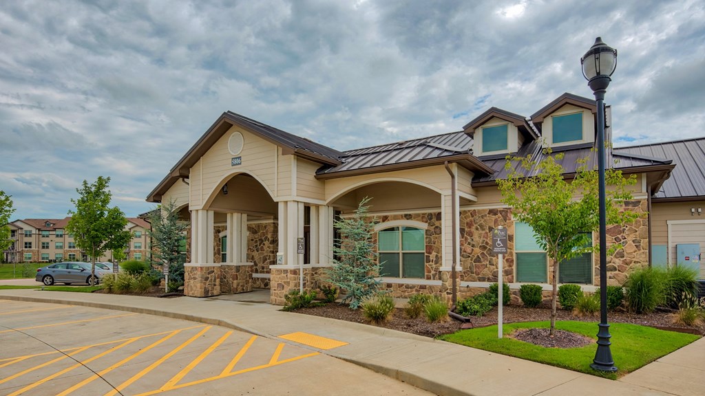 Outside photo of the clubhouse at Parc at Bentonville Apartments in Bentonville, AR