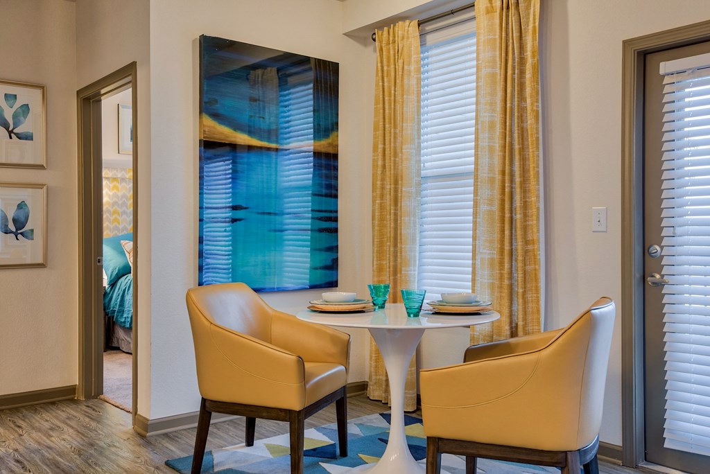 corner of living room space with coffee table and chairs at Parc at Bentonville Apartments in Bentonville, AR