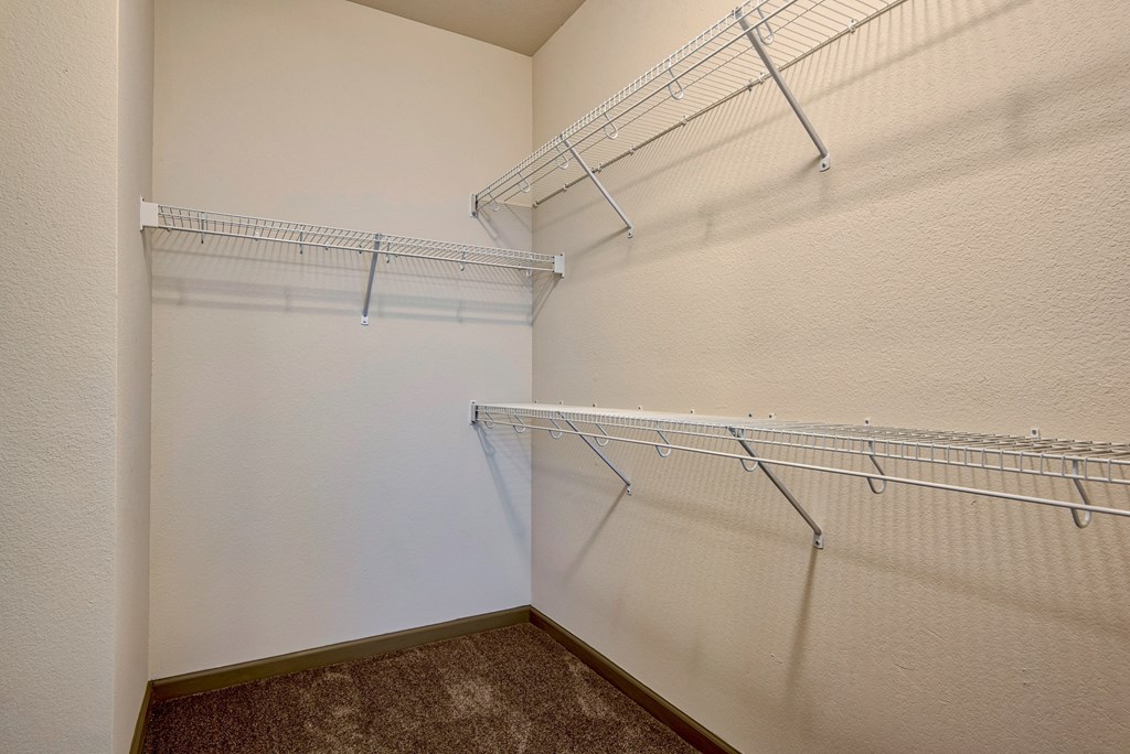 walk in closet with racks at Parc at Bentonville Apartments in Bentonville, AR