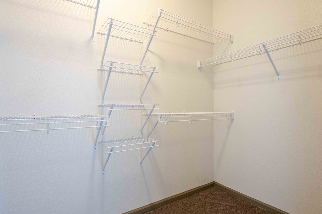 a walk in closet in a at Parc at Bentonville Apartments in Bentonville, AR