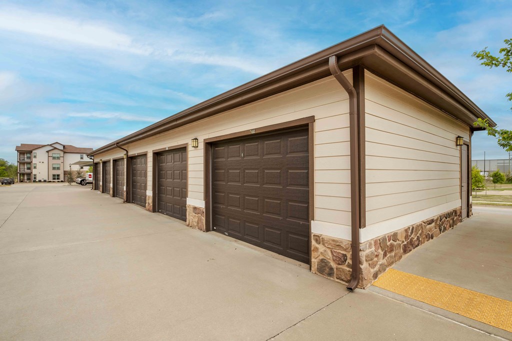 Pet-Friendly Rentals in Bentonville, AR – Parc at Bentonville – a row of garages in front of a building