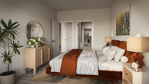 A bedroom with a large bed and a plant.