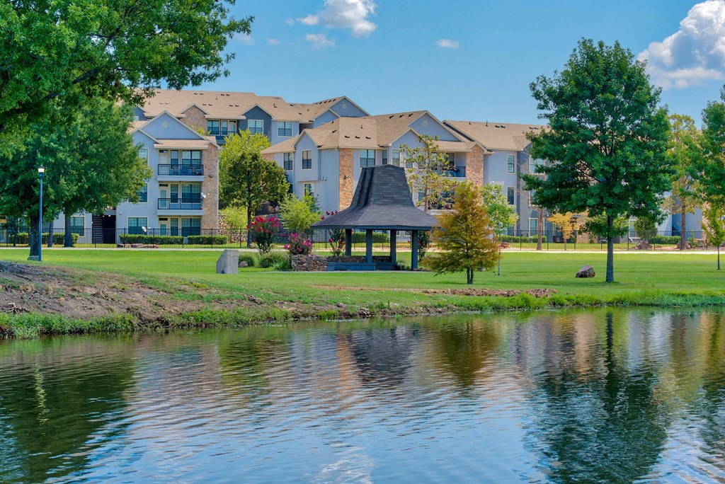 1, 2 & 3-Bedroom Apartments for Rent in Maumelle, AR – Parc at Maumelle –Exterior photo with a pond and covering