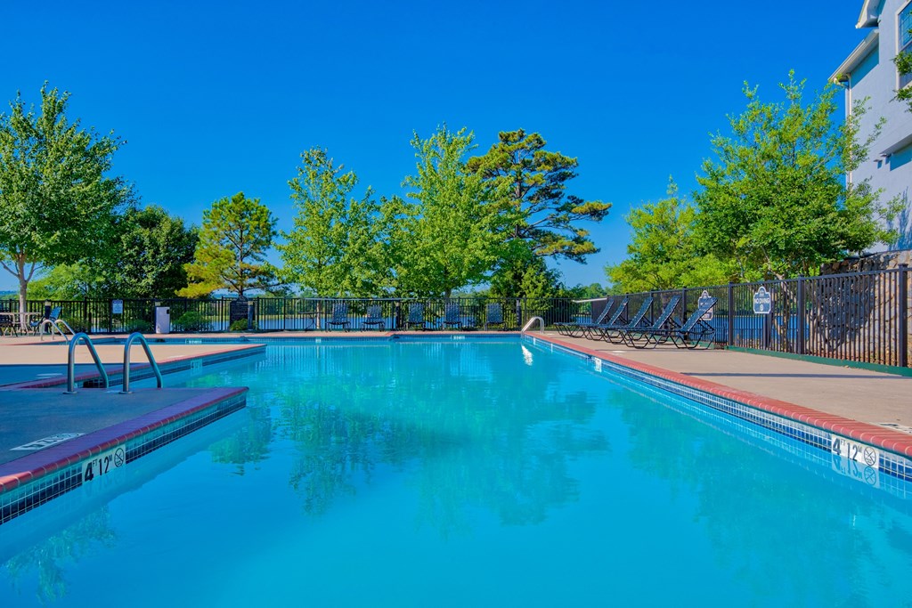 Pet-Friendly Rentals in Maumelle, AR – Parc at Maumelle – a swimming pool surrounded by trees and beach chairs