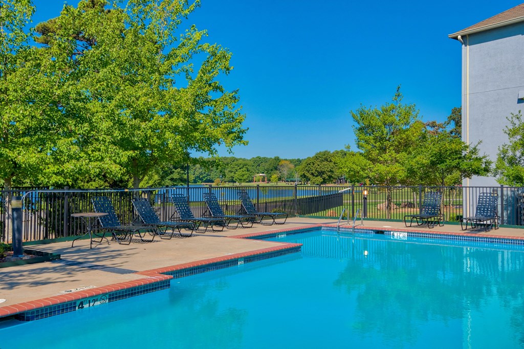 Pet-Friendly Rentals in Maumelle, AR – Parc at Maumelle – a swimming pool surrounded by trees and beach chairs