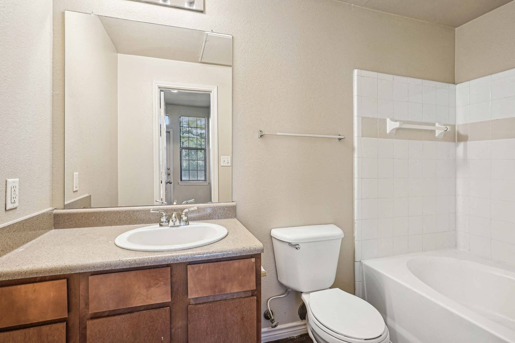 Apartments for Rent in Maumelle, AR 72113– Parc at Maumelle -   A bathroom with a white toilet and a white sink.