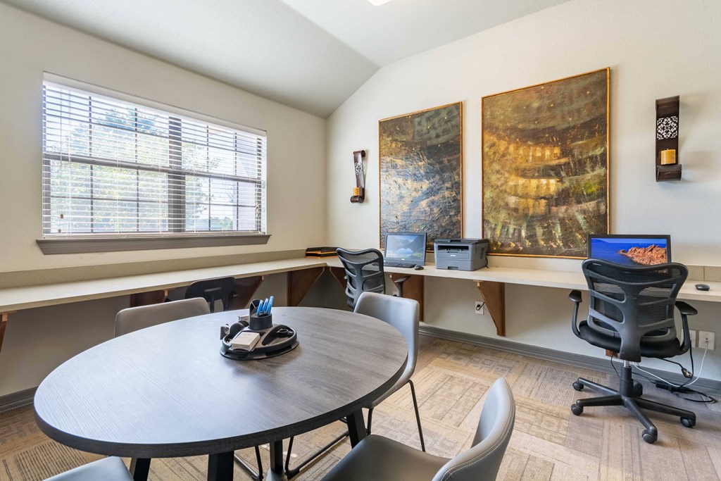 1, 2 & 3-Bedroom Apartments for Rent in Maumelle, AR – Parc at Maumelle – A office room with table and chairs and desks with cahirs