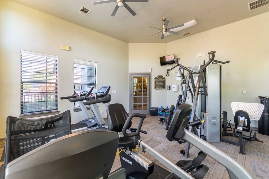 Pet-Friendly Rentals in Maumelle, AR – Parc at Maumelle – gym with cardio equipment and lifting equipment surrounded by windows