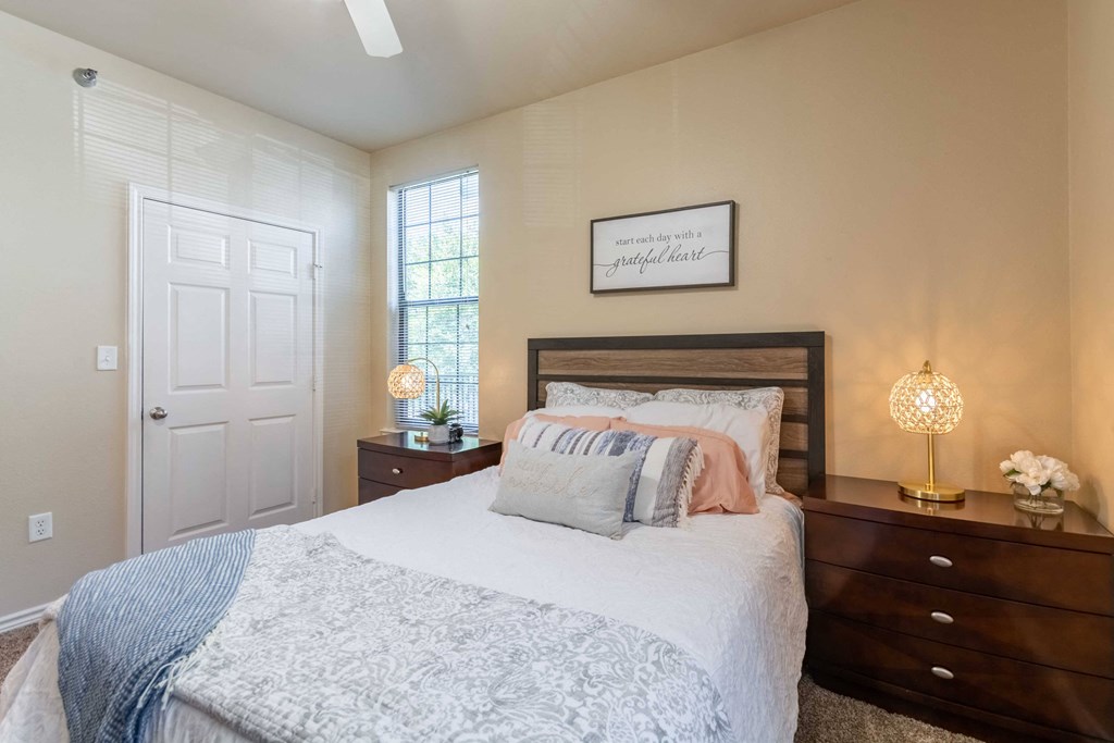 Bedroom with carpet floor and ceiling fan and windows