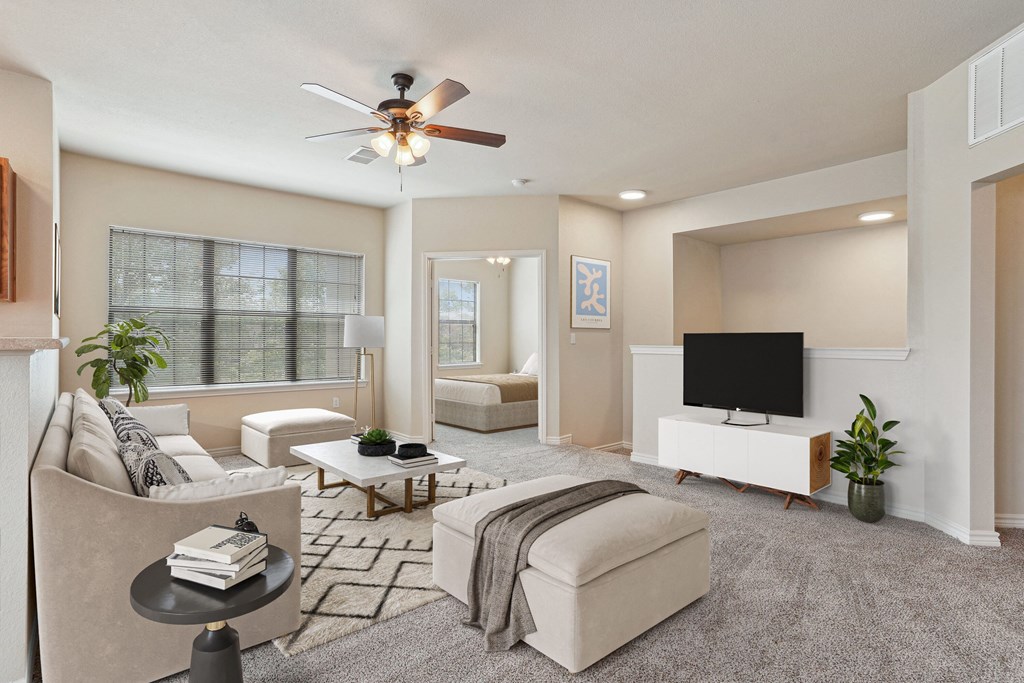 Apartments for Rent in Rogers, AR 72758– Parc at Rogers-   A living room with a ceiling fan and a flat screen TV.