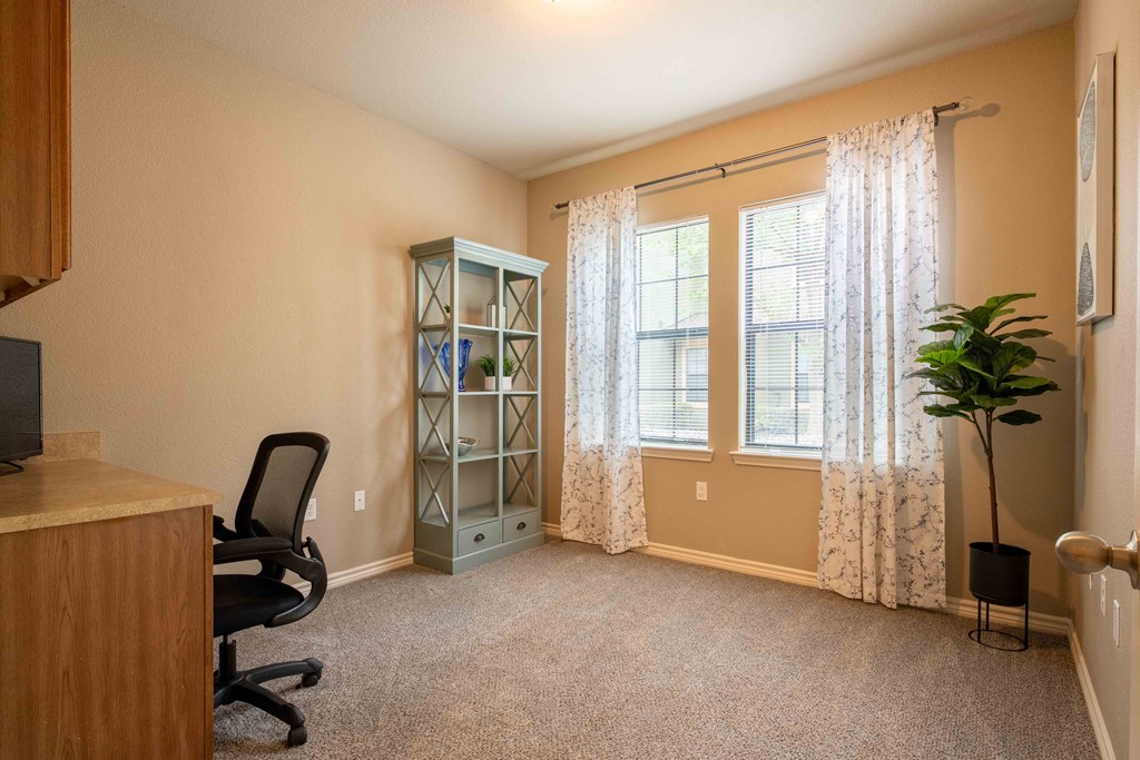 bedroom with a ceiling light/fan and carpet and doors