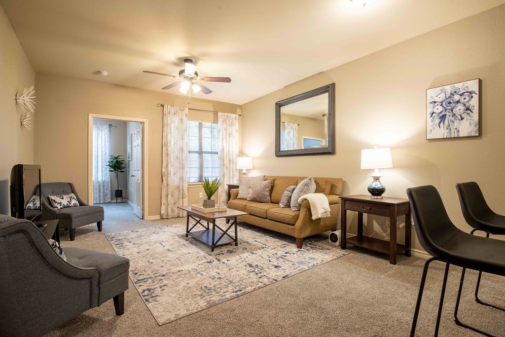 bedroom with a ceiling light/fan and carpet and doors and windows