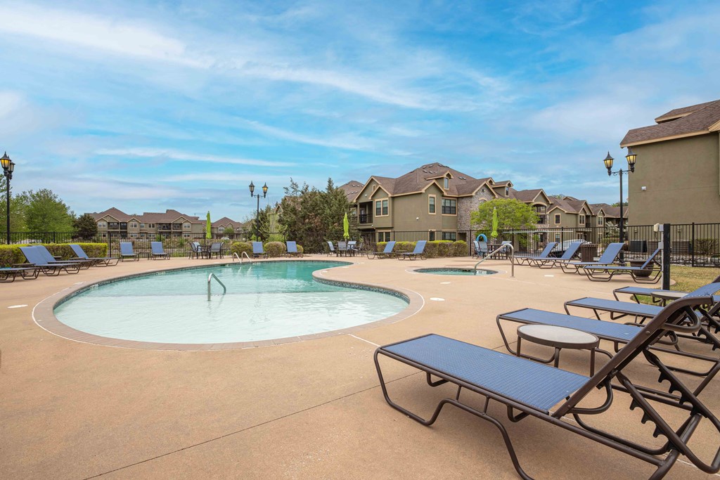 Pet-Friendly Rentals in Rogers, AR – Parc at Rogers – Swimming pool surrounded by apartments and beach chairs