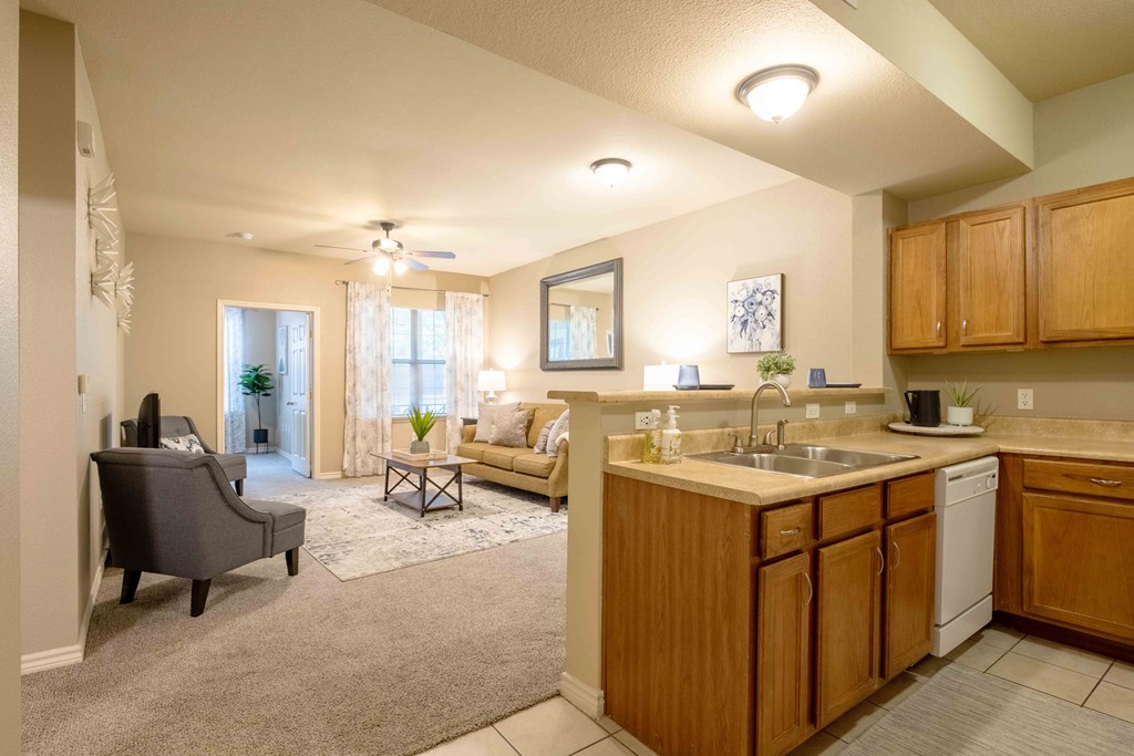 Kitchen with a sink and white appliances and wood cabinets