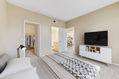 a bedroom with a large bed and a tv