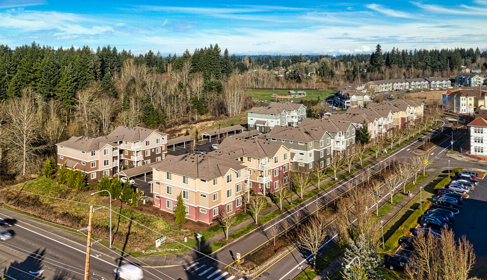 an aerial view of a row of houses next to a street