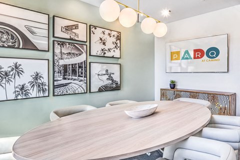 a dining room with a wooden table and white chairs