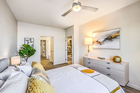 a bedroom with a large bed and a ceiling fan