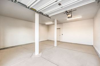 an empty room with white walls and pillars