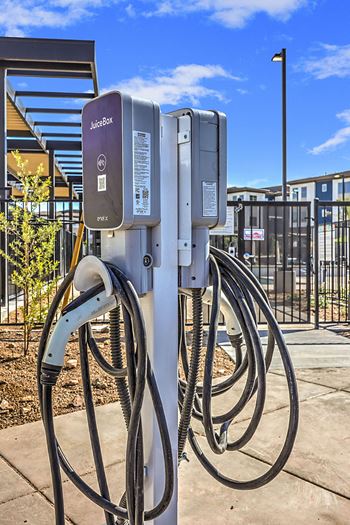 a charging station with a bunch of cables plugged into it