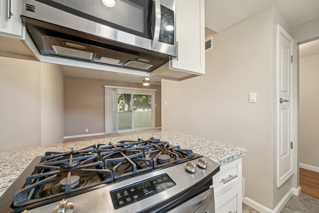 a kitchen with a stove top oven and a microwave