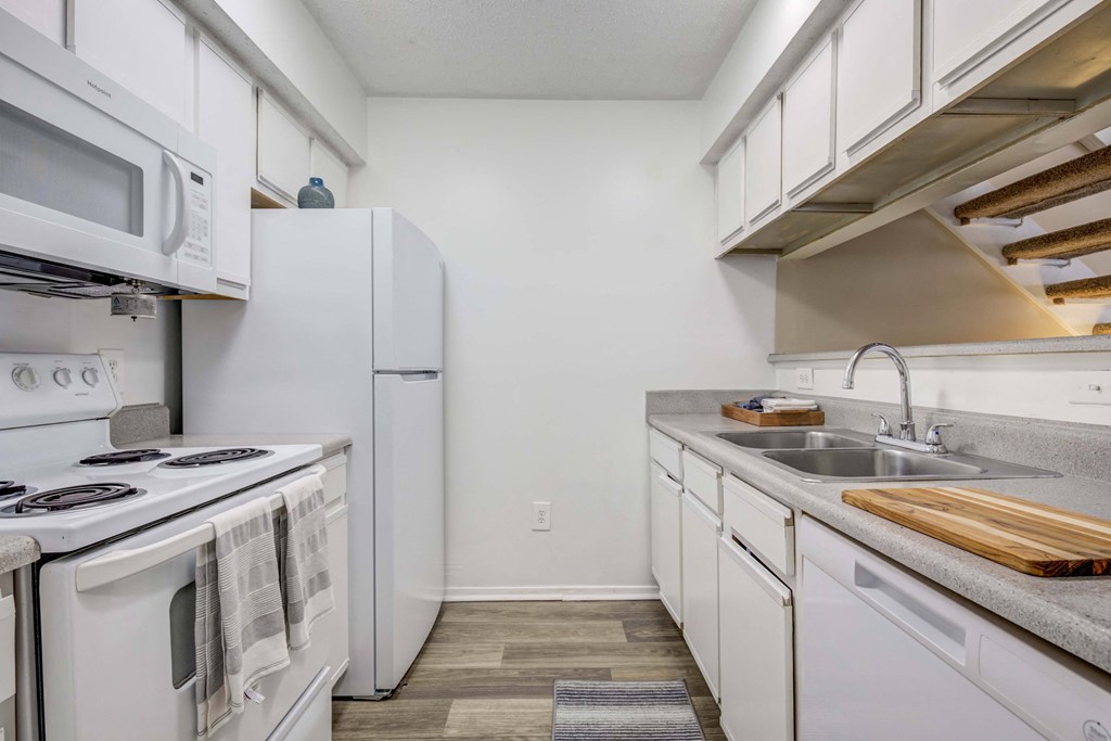 The Pearl at Highland Village Apartments and Townhomes for rent in Jackson, MS photo of a kitchen with white appliances and white cabinets