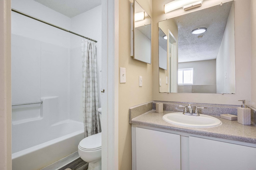 The Pearl at Highland Village Apartments and Townhomes for rent in Jackson, MS photo of a bathroom with a sink and a shower and a toilet