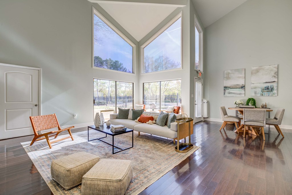 The Pearl at Highland Village Apartments and Townhomes for rent in Jackson, MS photo of a living room with large windows and a couch