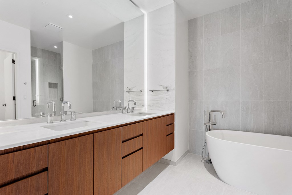 a bathroom with two sinks and a bathtub