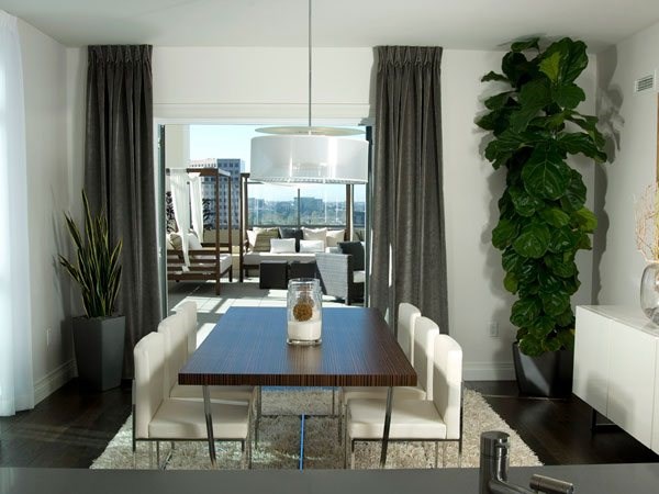 A dining room with a table and chairs.